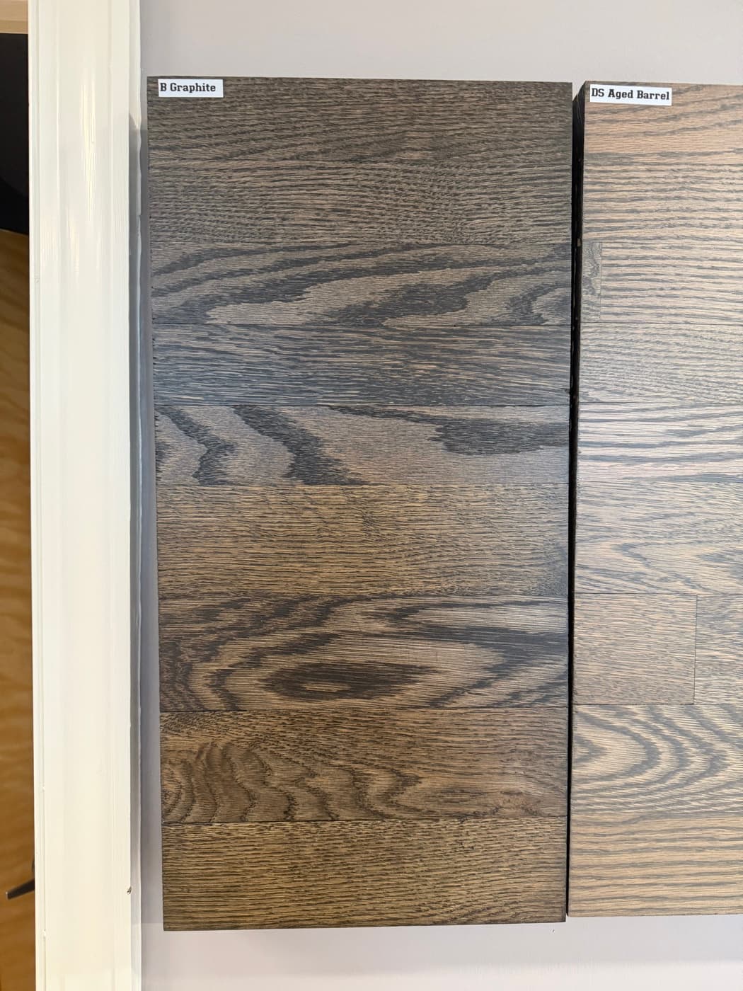 Bona Graphite stain on showroom wall board showing cool gray tone: top half 2.25 inch red oak, bottom half 3.25 inch white oak