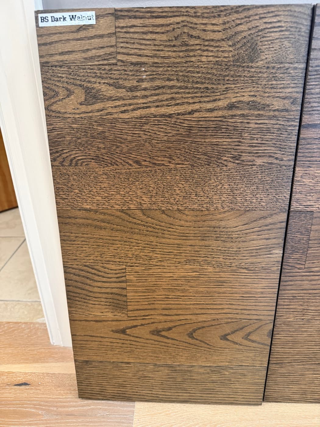 Berger Seidle Dark Walnut hardwax oil on showroom wall board showing rich dark brown tone: top half 2.25 inch red oak, bottom half 3.25 inch white oak