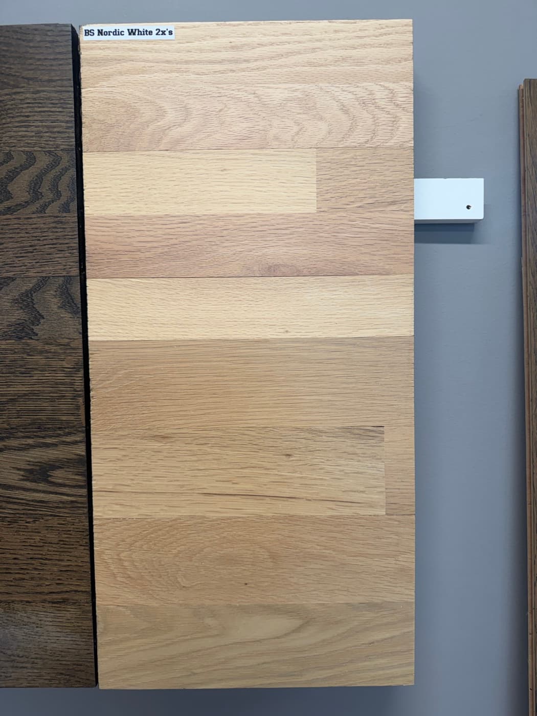 Berger Seidle Nordic White sealer applied twice on showroom wall board preserving the freshly sanded bare wood look: top half red oak, bottom half white oak