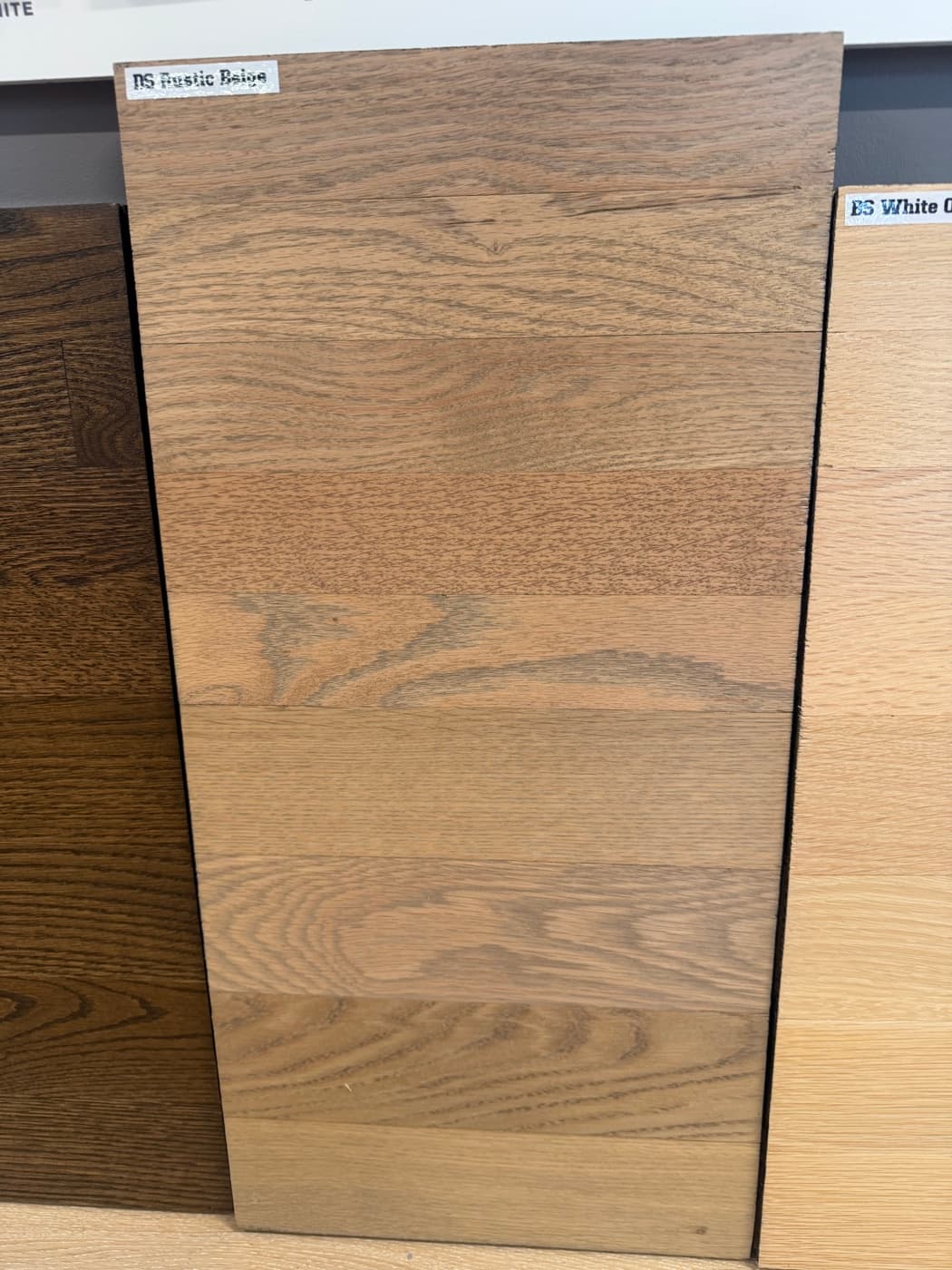 Berger Seidle Rustic Beige hardwax oil on showroom wall board: top half 2.25 inch red oak, bottom half 3.25 inch white oak
