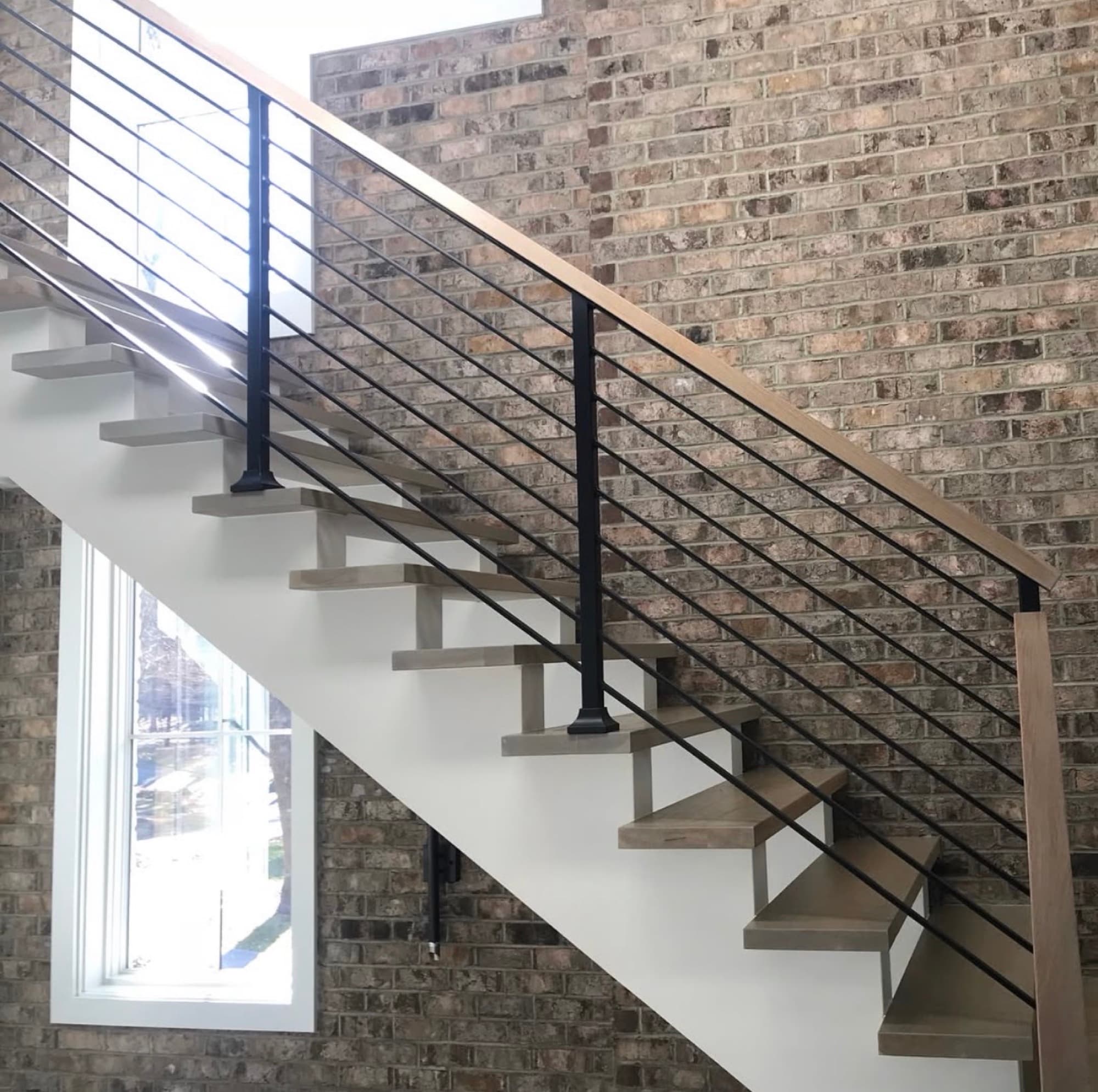 White oak floating stair treads with horizontal rail remodel in Raleigh NC