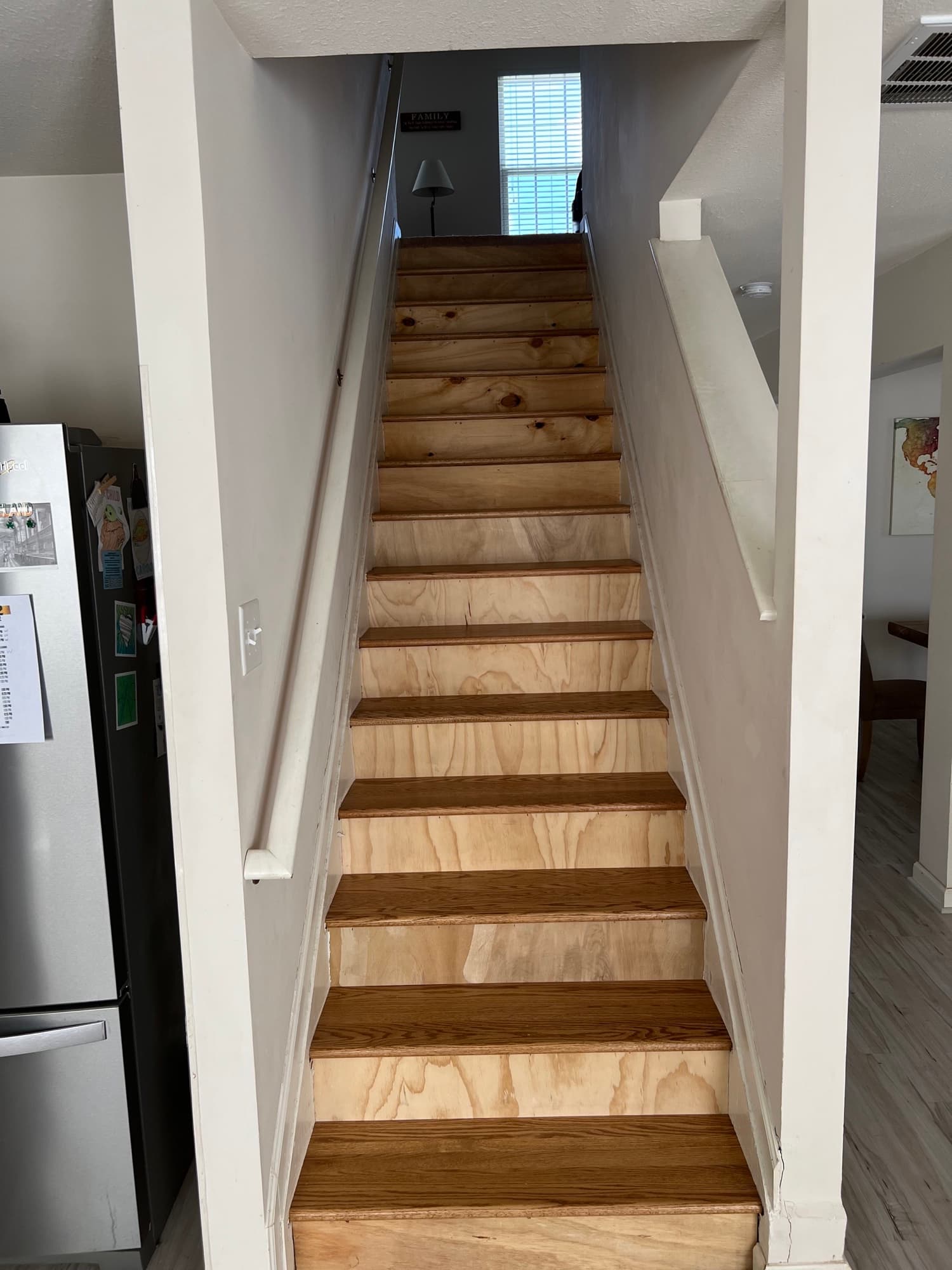 Staircase substructure exposed and prepped before hardwood tread installation by 12th And Oak Floor Co. Clayton NC