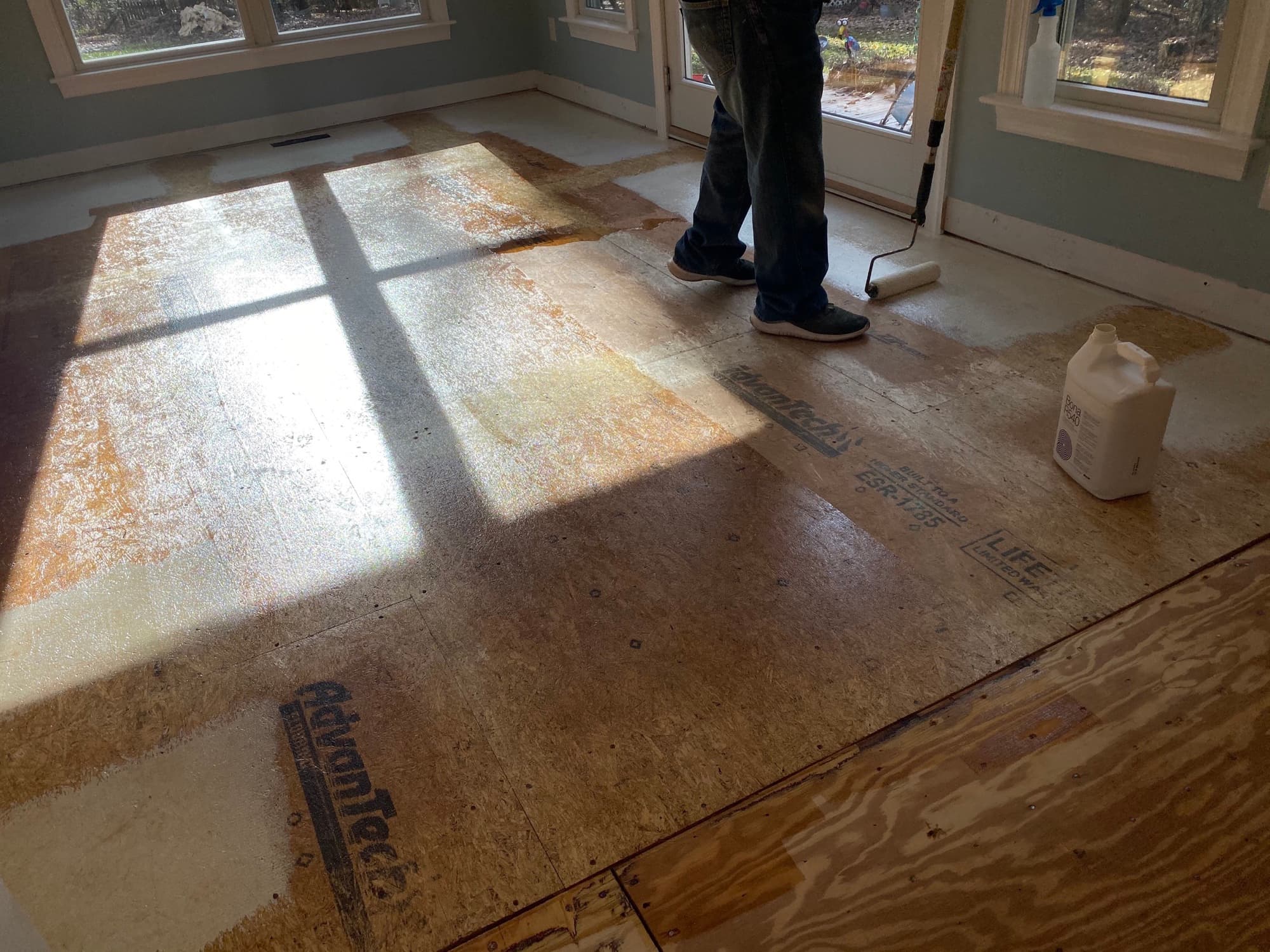 Plywood subfloor prepared before a hardwood floor installation, the layer every squeak lives in